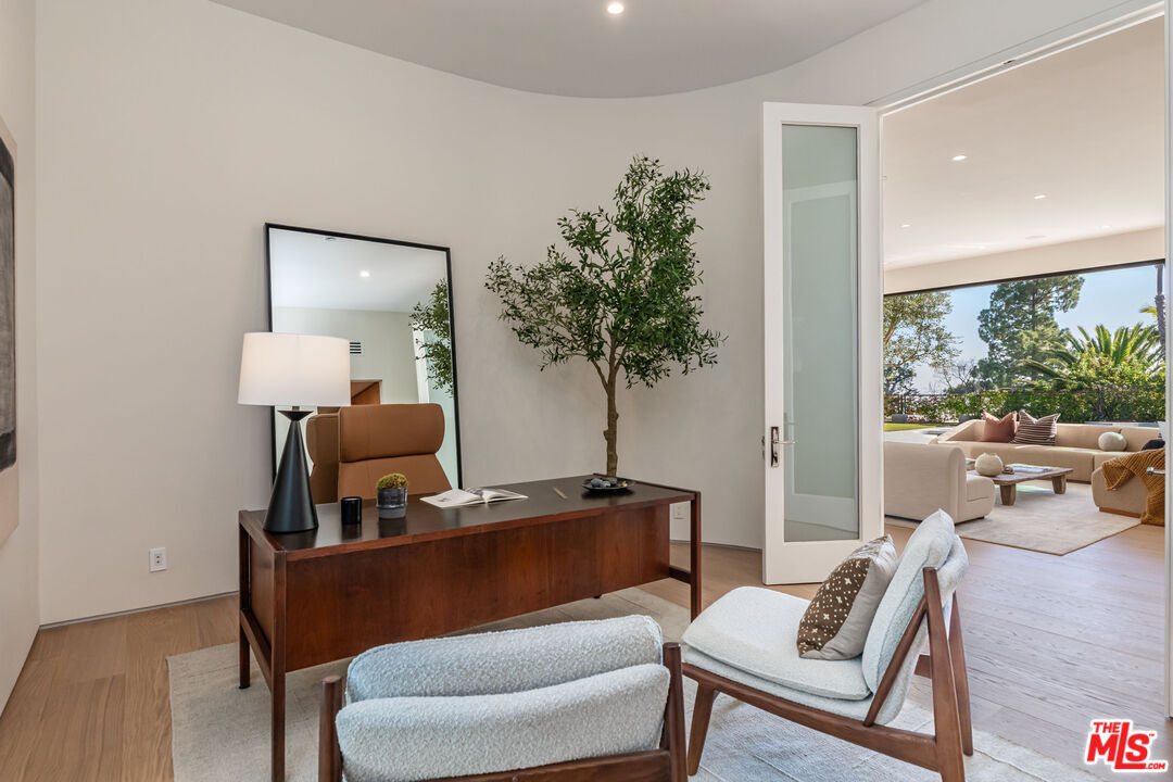 1705 Carla Ridge Beverly Hills, CA 90210 - Photo 26 of 39 a living room with furniture and a potted plant