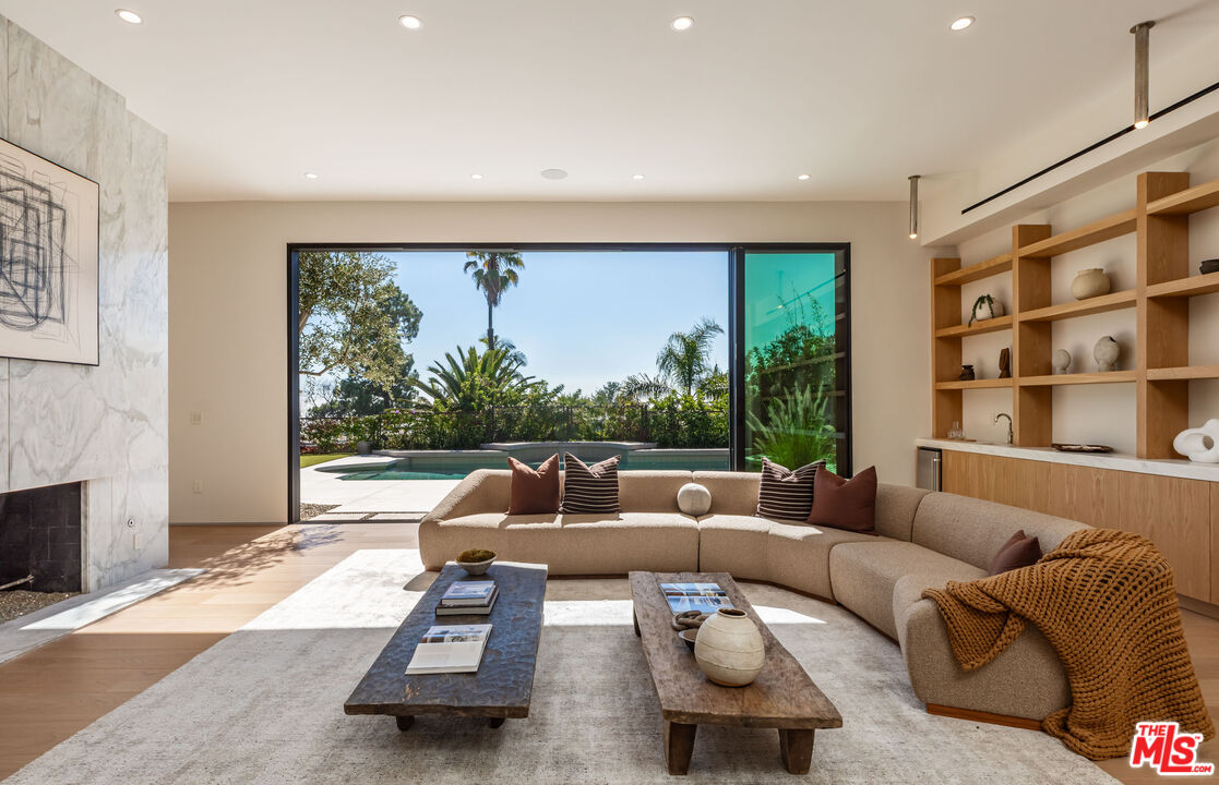 1705 Carla Ridge Beverly Hills, CA 90210 - Photo 3 of 39 a living room with furniture and a large window