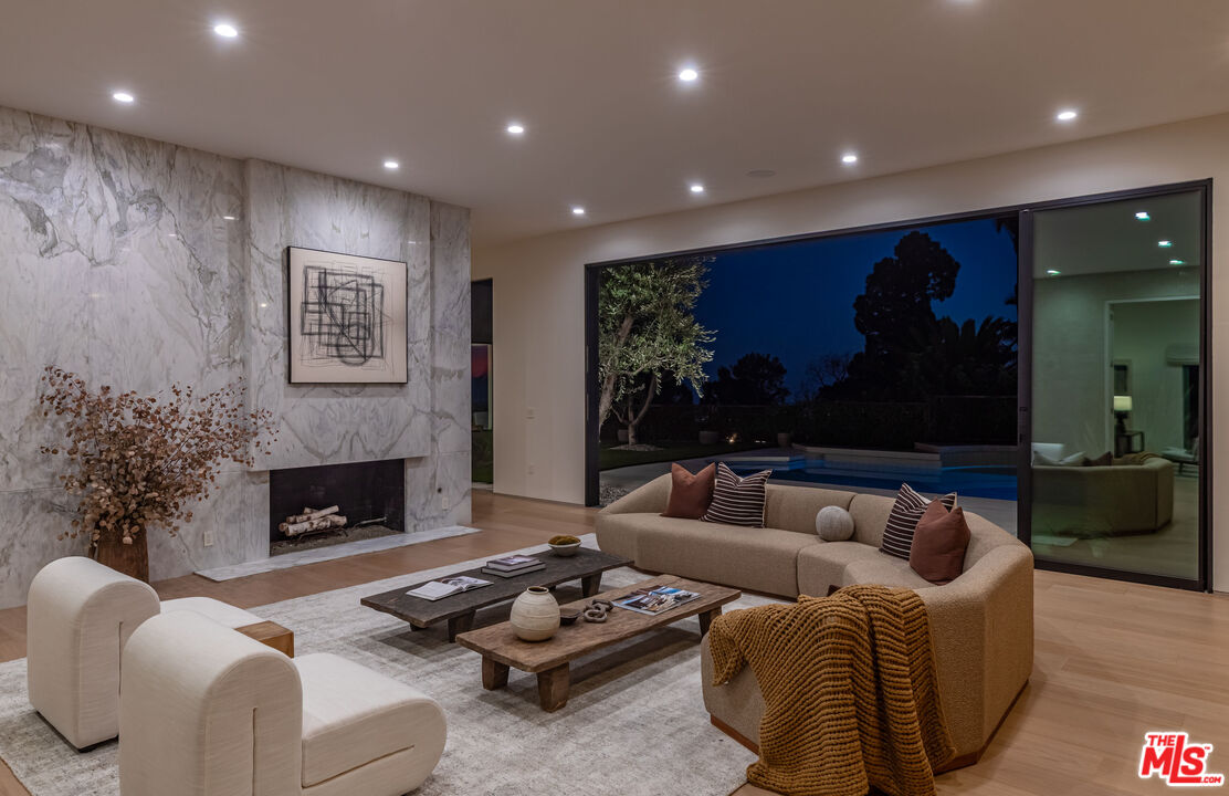 1705 Carla Ridge Beverly Hills, CA 90210 - Photo 33 of 39 a living room with furniture and a fireplace