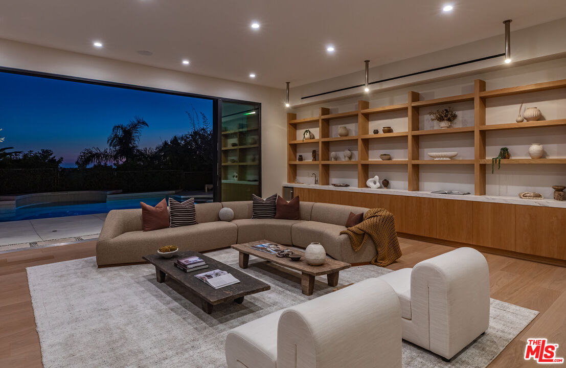 1705 Carla Ridge Beverly Hills, CA 90210 - Photo 34 of 39 a living room with furniture and a flat screen tv