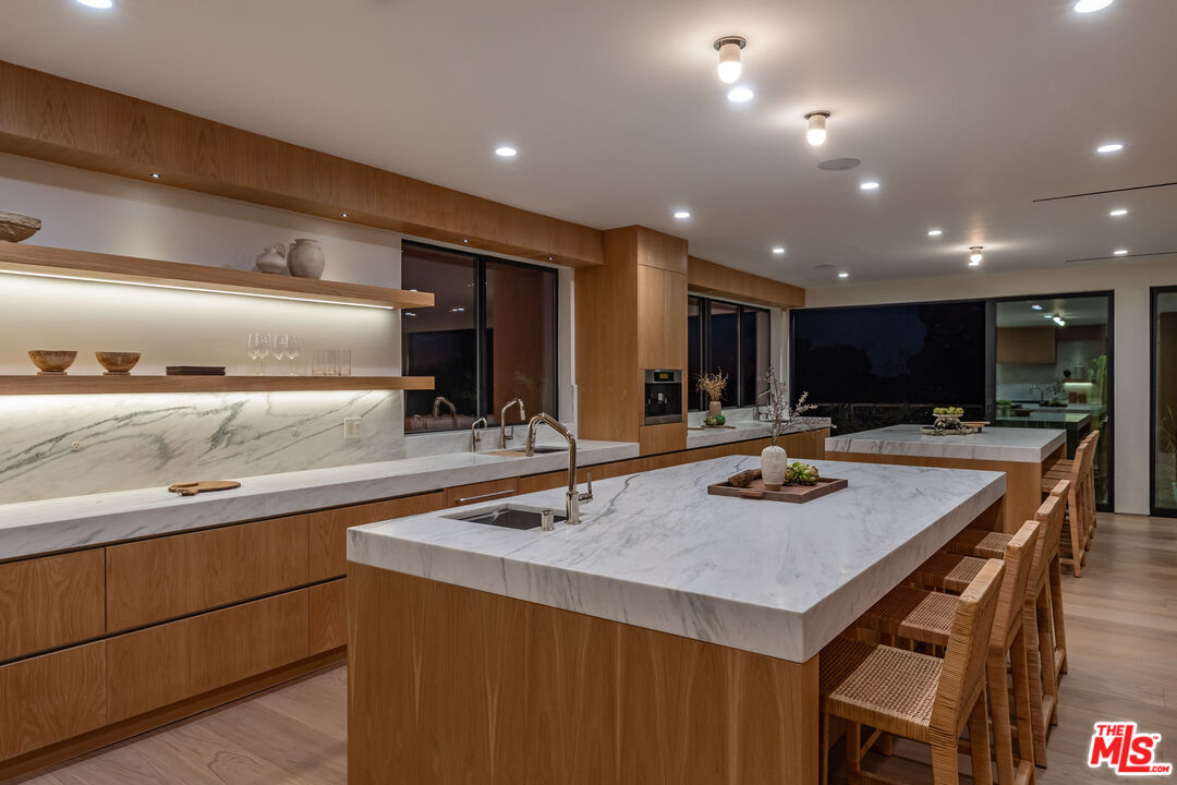1705 Carla Ridge Beverly Hills, CA 90210 - Photo 35 of 39 a kitchen with a sink a counter space and cabinets