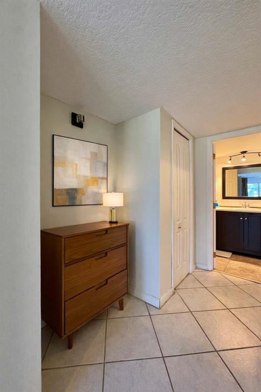 2601 South Course Drive, Unit 305 Pompano Beach, FL 33069 - Photo 14 of 20 a room with a dresser and a mirror