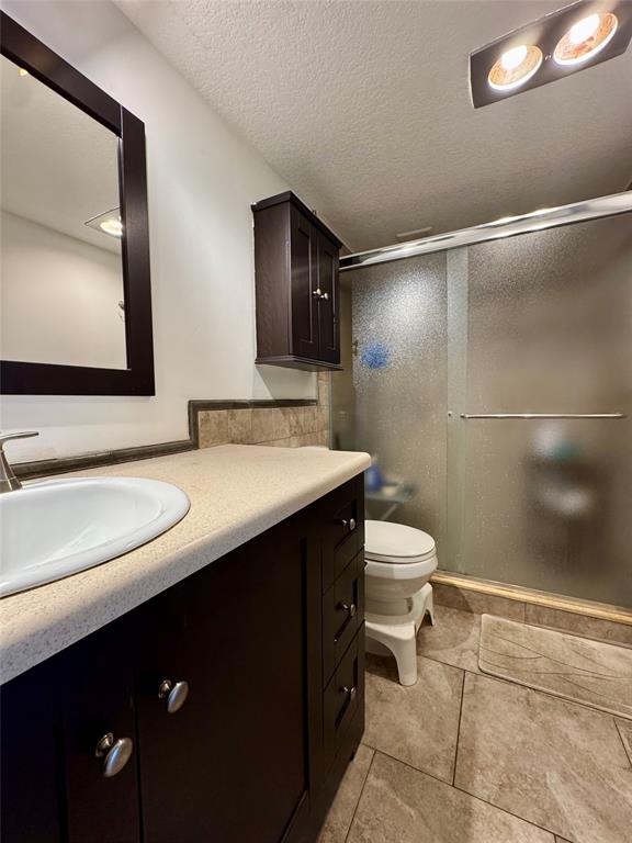 2601 South Course Drive, Unit 305 Pompano Beach, FL 33069 - Photo 15 of 20 a bathroom with a sink a toilet and mirror