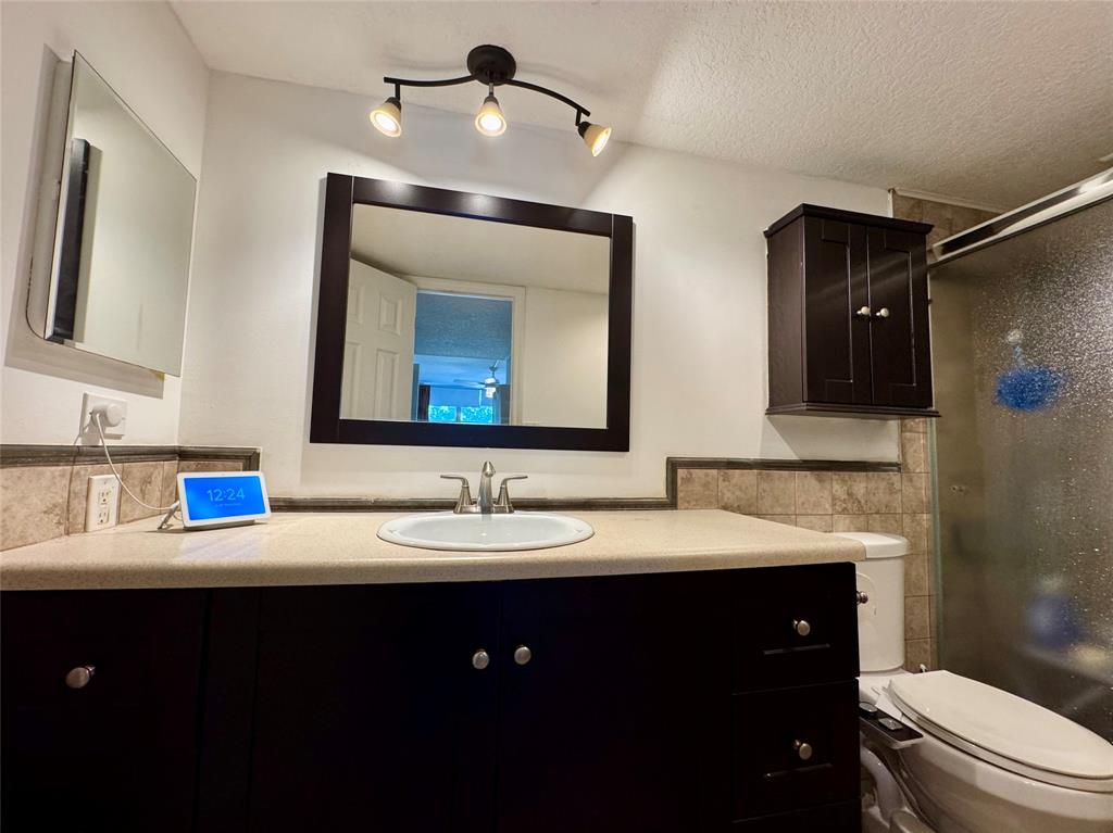 2601 South Course Drive, Unit 305 Pompano Beach, FL 33069 - Photo 16 of 20 a bathroom with a double vanity sink and a mirror