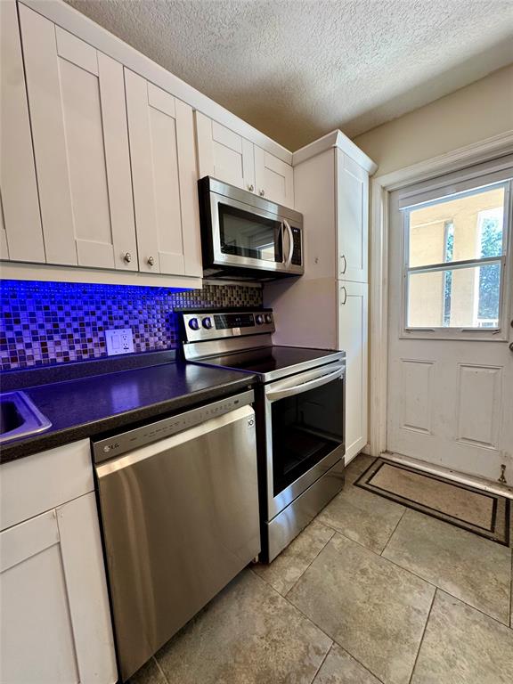 2601 South Course Drive, Unit 305 Pompano Beach, FL 33069 - Photo 20 of 20 a kitchen with stainless steel appliances a stove microwave and refrigerator