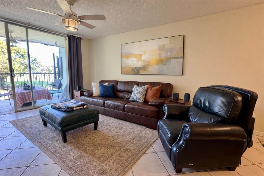 2601 South Course Drive, Unit 305 Pompano Beach, FL 33069 - Photo 5 of 20 a living room with furniture and a window
