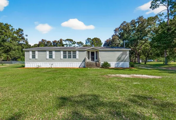 a view of a house with a backyard