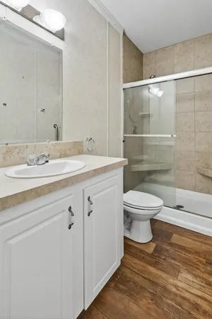 a bathroom with a sink a toilet and shower