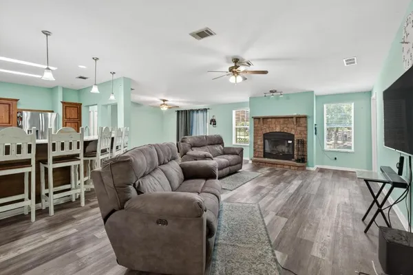 a living room with furniture fireplace and a flat screen tv
