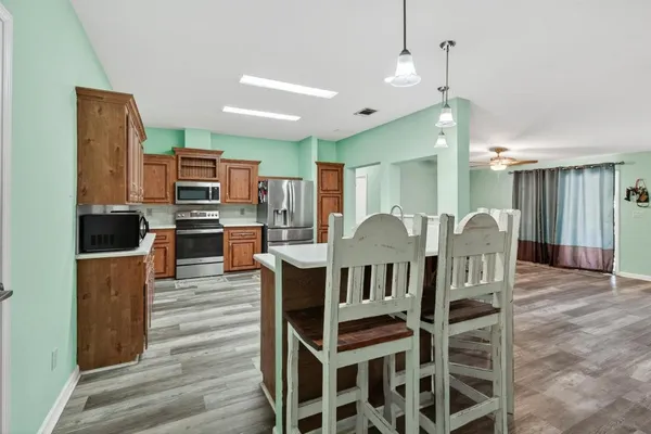 a large kitchen with a table and chairs