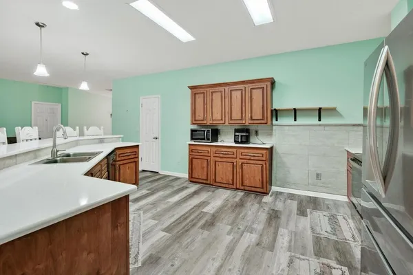 a kitchen with stainless steel appliances a refrigerator and a stove