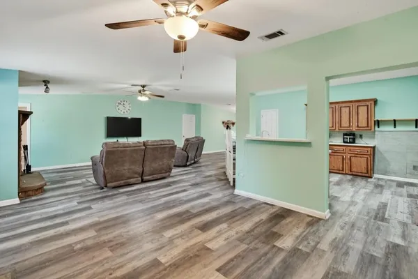 a living room with furniture and flat screen tv
