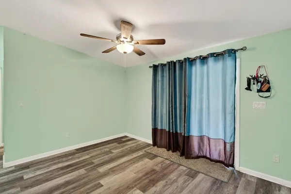 a view of a hallway with closet and window