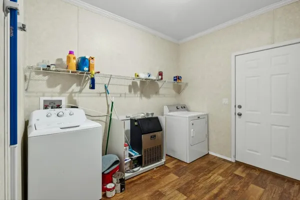 a view of storage and utility room with two washing machine