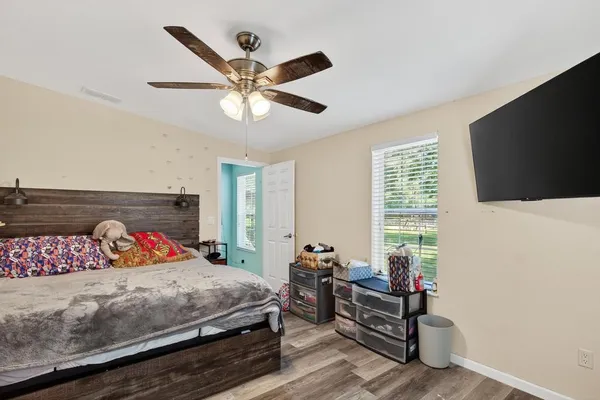 a bedroom with a bed and a flat screen tv