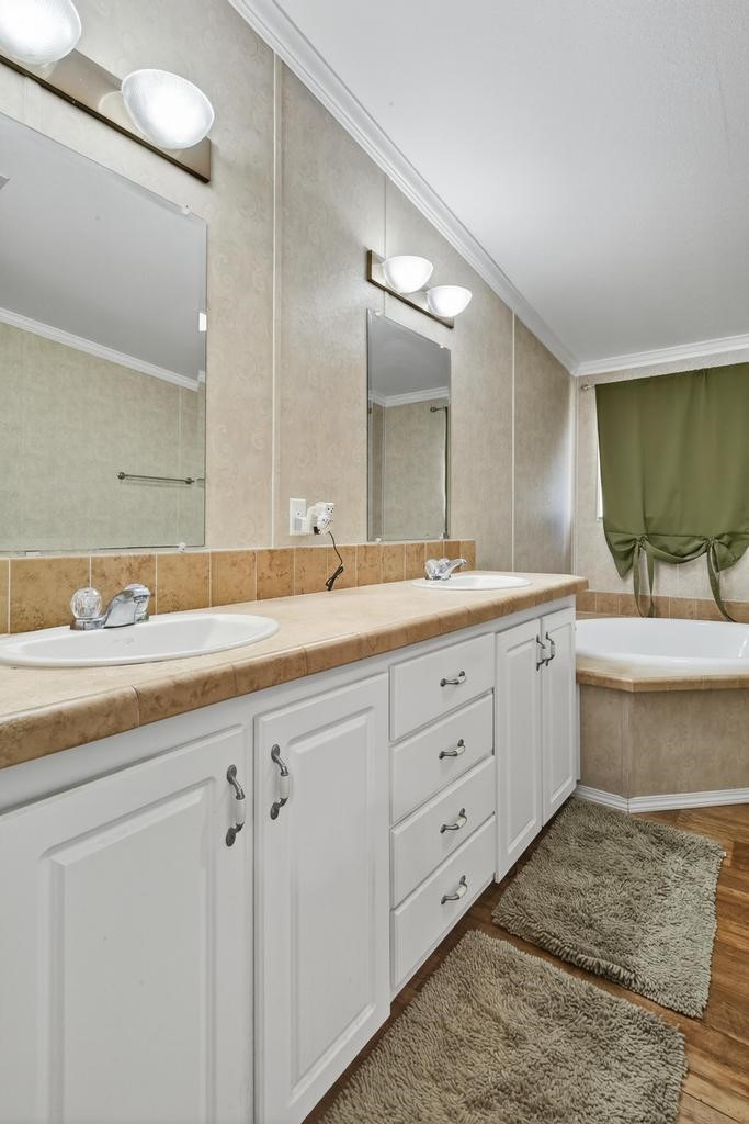 85614 Wilson Neck Road Yulee, FL 32097 - Photo 39 of 48 a bathroom with a double vanity sink and a mirror