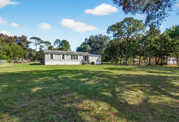 a view of a house with a big yard