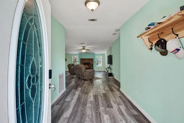 a view of a bedroom with wooden floor and stairs