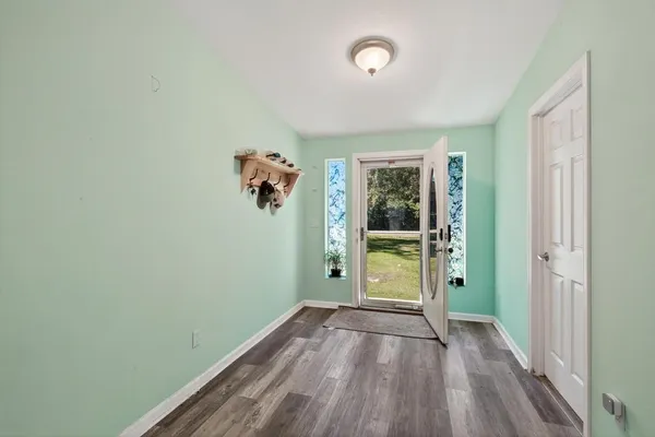 wooden floor in an empty room with a window