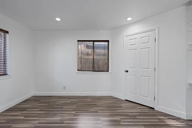 a large kitchen with stainless steel appliances granite countertop a large counter top a stove and a sink