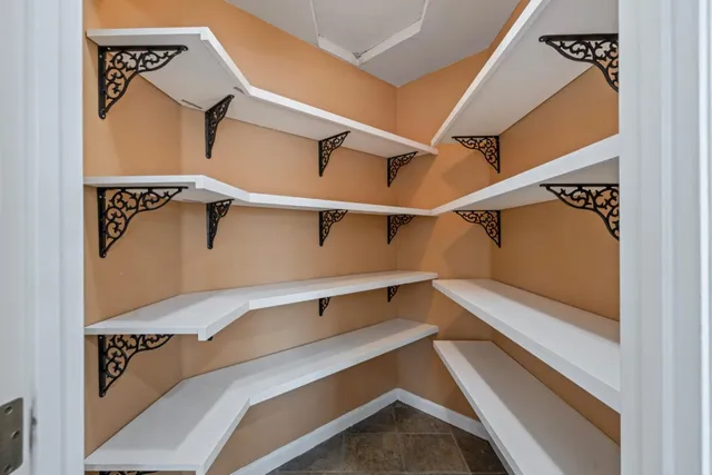 a view of a livingroom with wooden floor and furniture