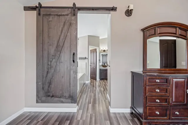 a view of an empty room with window and a chandelier fan