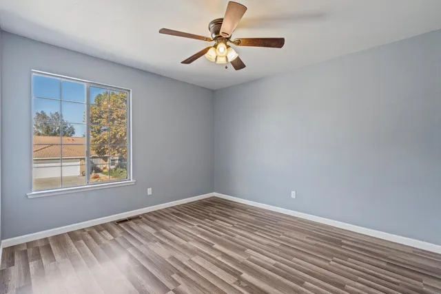 a view of a backyard with table and chairs under an umbrella