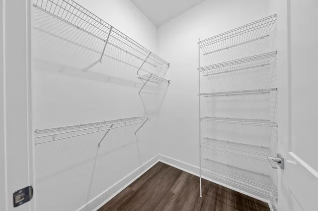 a view of walk in closet with empty racks