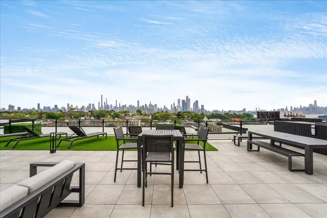 a view of a terrace with furniture and a fire pit