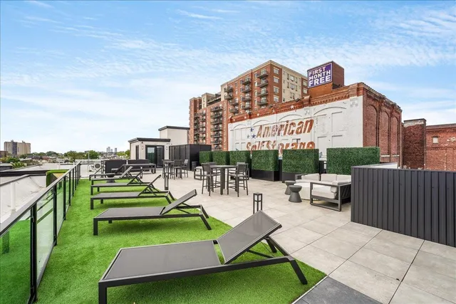 a view of a terrace with couches and city view