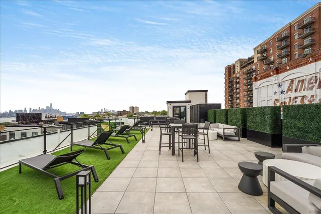 a view of a terrace with couches and city view