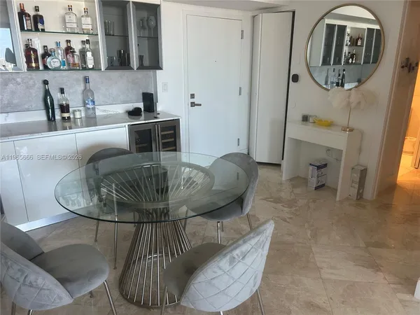 a dining room with furniture and a chandelier
