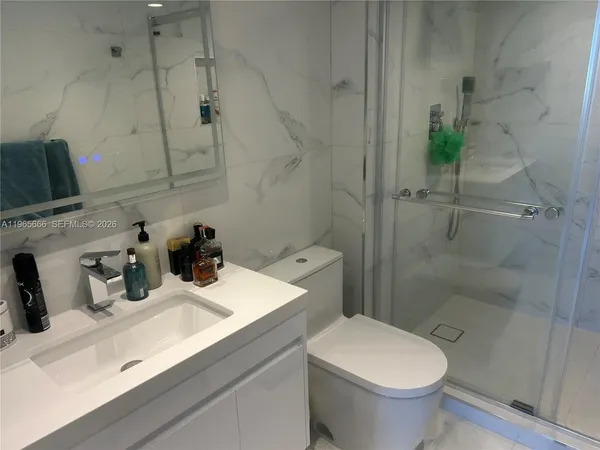 a bathroom with a sink toilet and shower