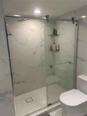 a bathroom with a shower and a toilet
