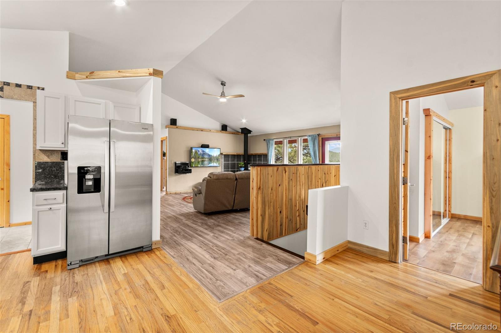 202 Badger Lane Bailey, CO 80421 - Photo 9 of 50 a kitchen with stainless steel appliances a refrigerator and wooden floor