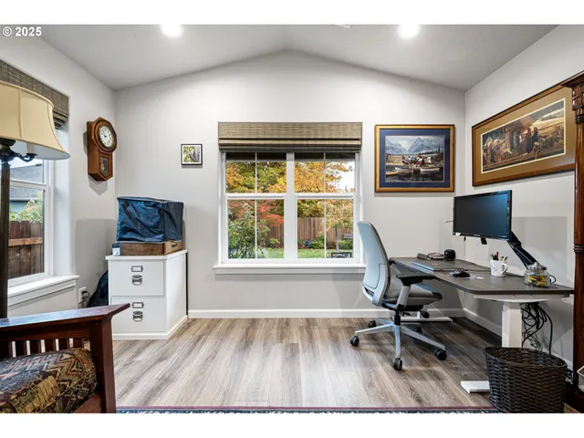 a workspace with lounge chair and a window