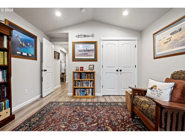 a living room with furniture and baby crib