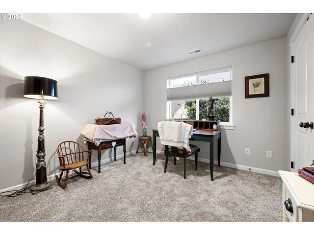 a living room with furniture a window and a flat screen tv