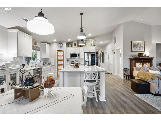 a living room with furniture and kitchen view