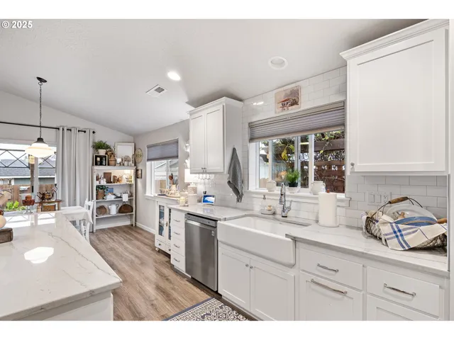 a open kitchen with stainless steel appliances kitchen island granite countertop a sink dishwasher stove and cabinets