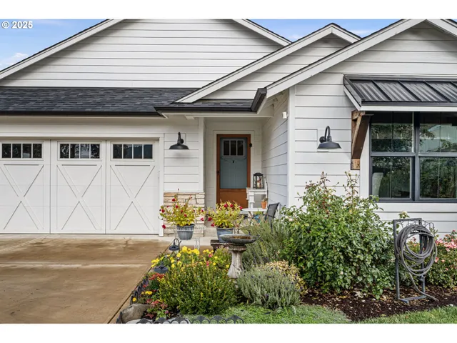 a front view of a house with a garden