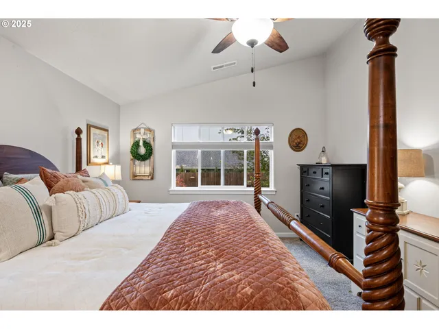 a spacious bedroom with a bed and a chandelier