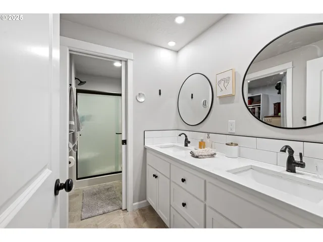 a bathroom with a double vanity sink and a mirror