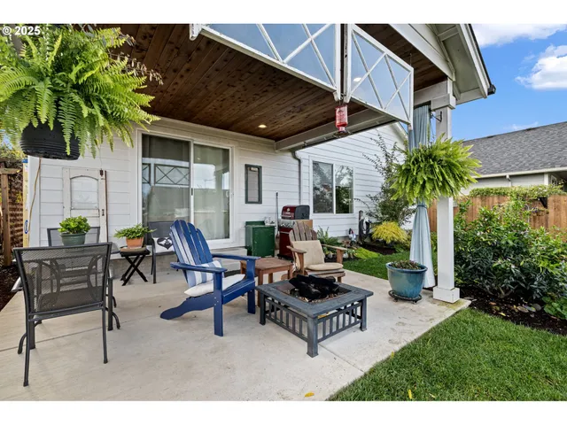a backyard of a house with fire pit and furniture