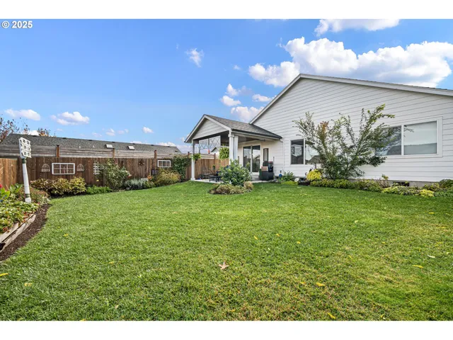 a front view of a house with a yard and trees