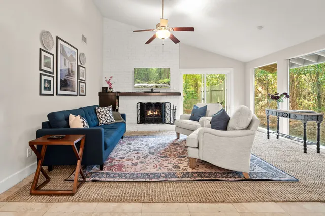 a living room with furniture a rug and a fireplace