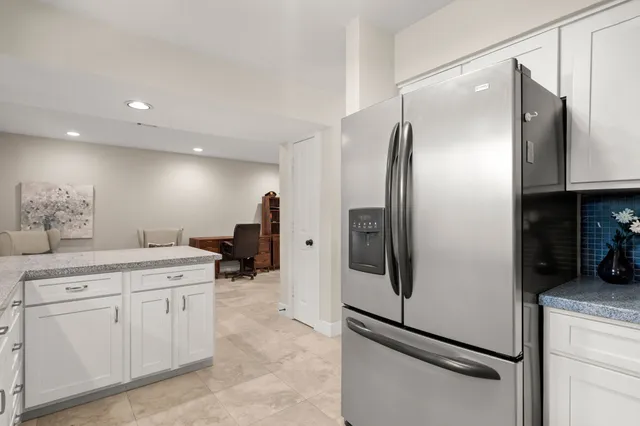 a kitchen with stainless steel appliances a refrigerator sink and cabinets