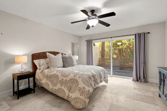 a spacious bedroom with a bed and a large window