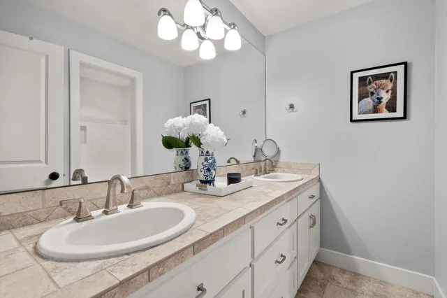 a bathroom with a double vanity sink and a mirror