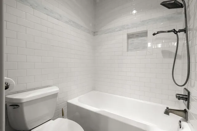 a bathroom with a toilet and a bathtub